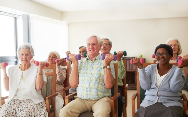 Elderly people exercising in chairs