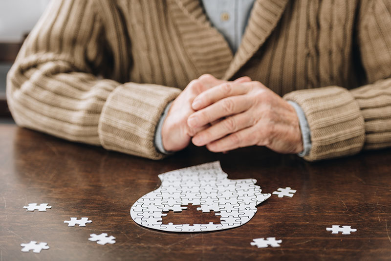 Man doing puzzle representing dementia