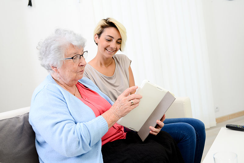 Live-in carer keeping elderly lady company at home