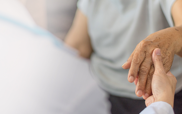 Elderly Person's Hand being held