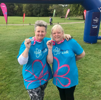 Gail and Hayley holding their meddles after completing a walk for charity