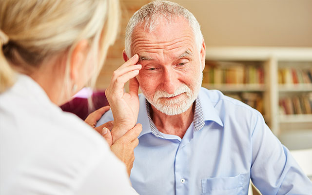 man holding head alzheimers