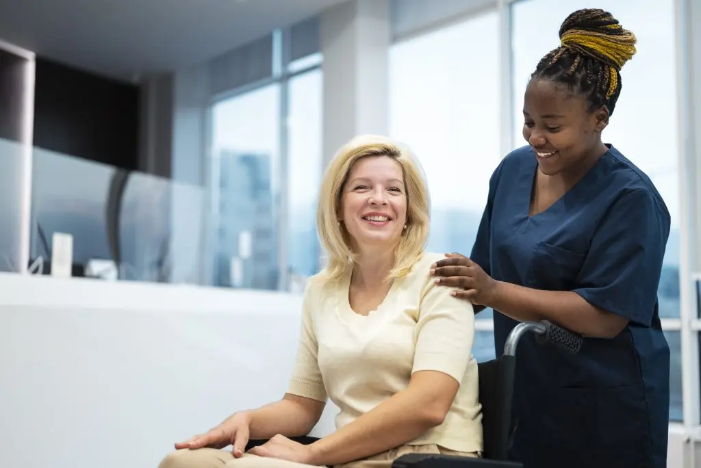 A live-in carer smiling with a patient